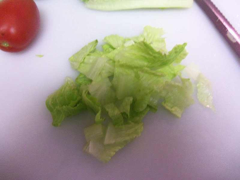 Clean and wash the romaine lettuce, then chop it into small, bite-size pieces.