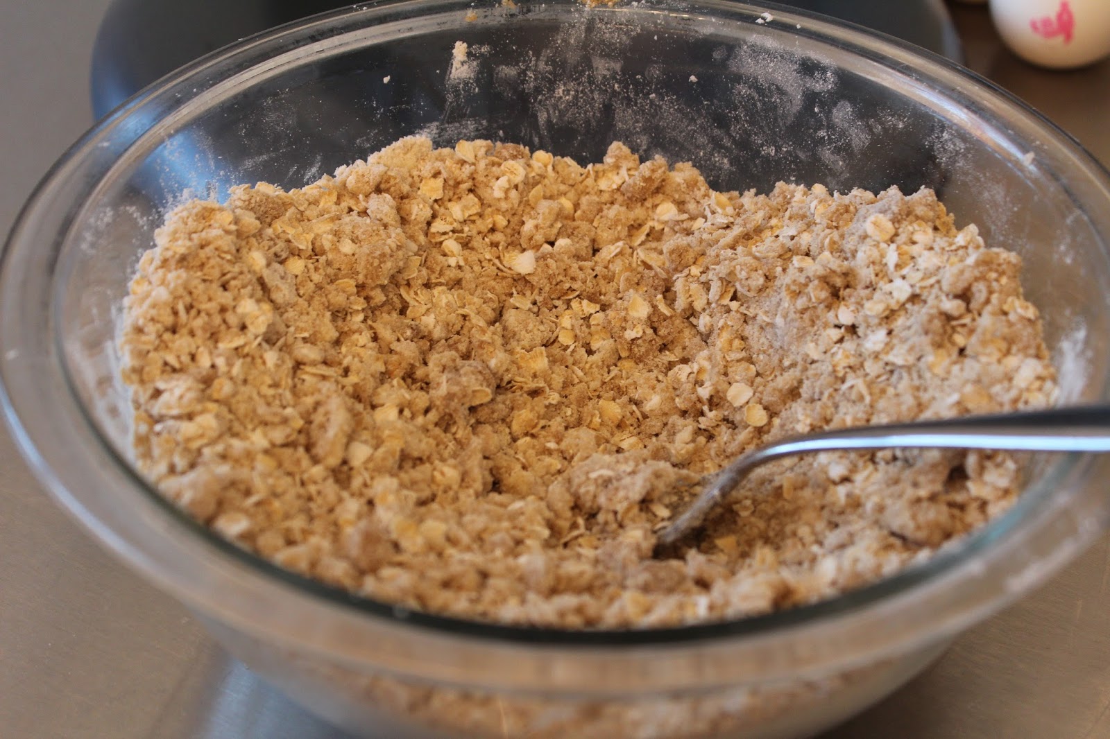 In a separate bowl, mix brown sugar, softened butter, shortening, flour, and oats until crumbly