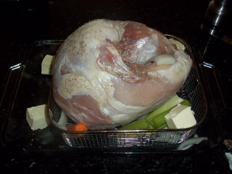 Place the turkey breast in a roasting pan with a roasting rack underneath and add the vegetables to the pan