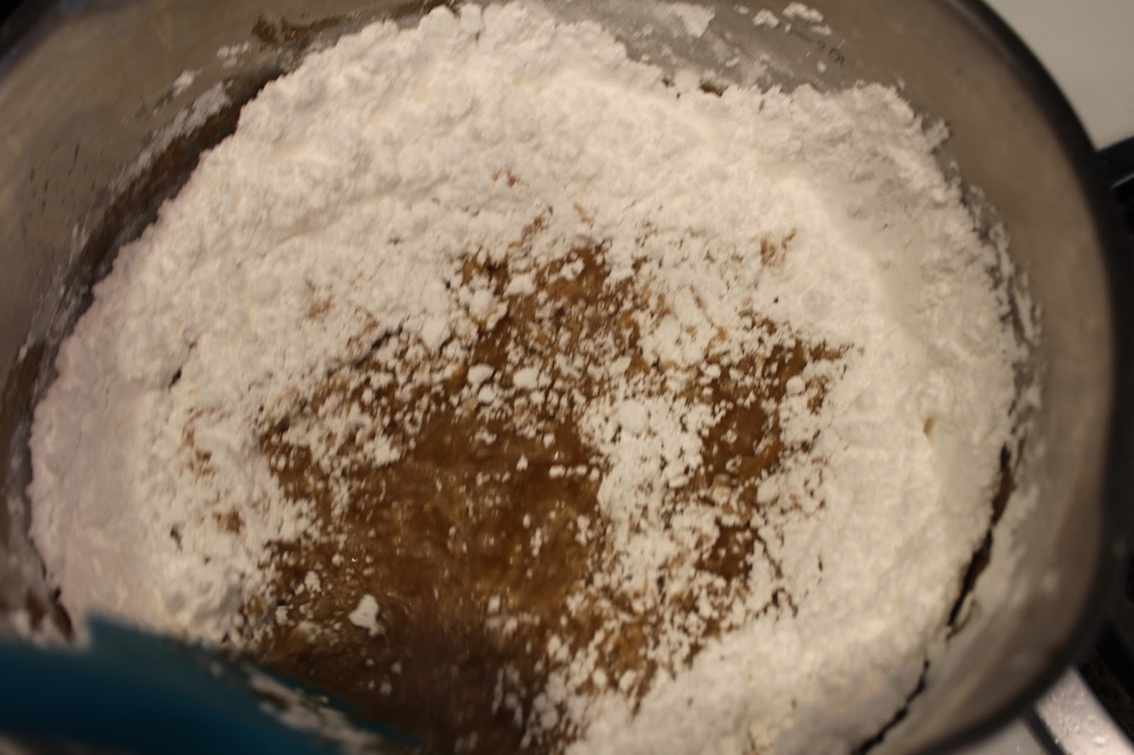 Gradually add sifted powdered sugar, mixing until smooth. Let cool slightly until thick enough to pipe