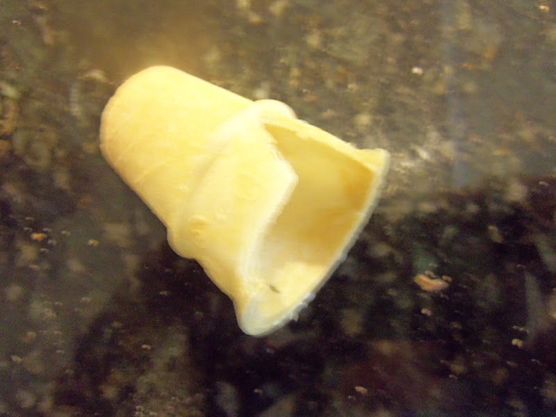Cut a section of a cake cone so it fits the roof and attach it with icing