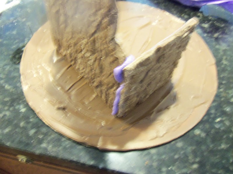 Melt additional chocolate and spread it over a cake circle. Allow it to dry for about 1 hour