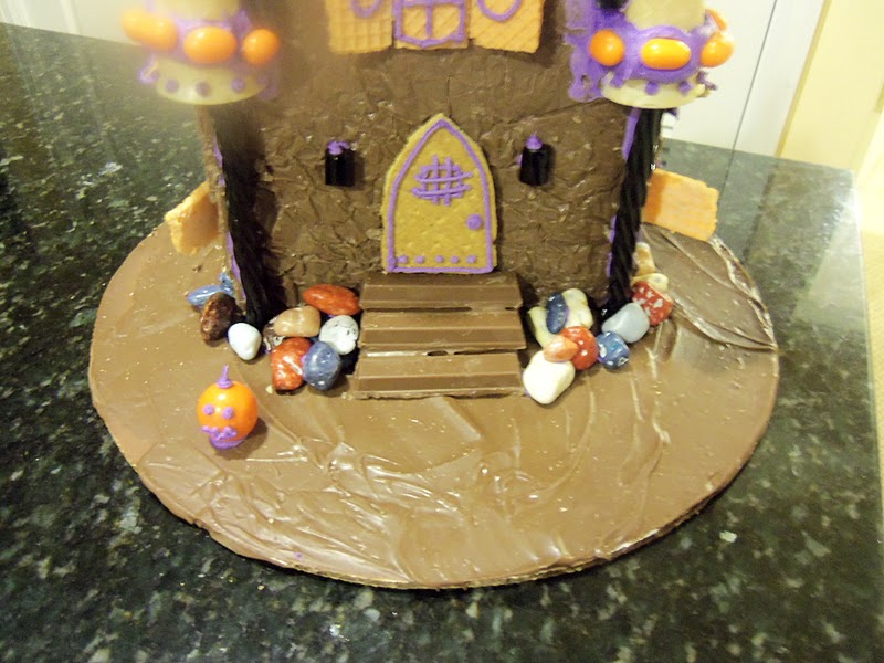 Place a Reese's Piece at the top of each window and add an orange gumball to create a pumpkin detail.