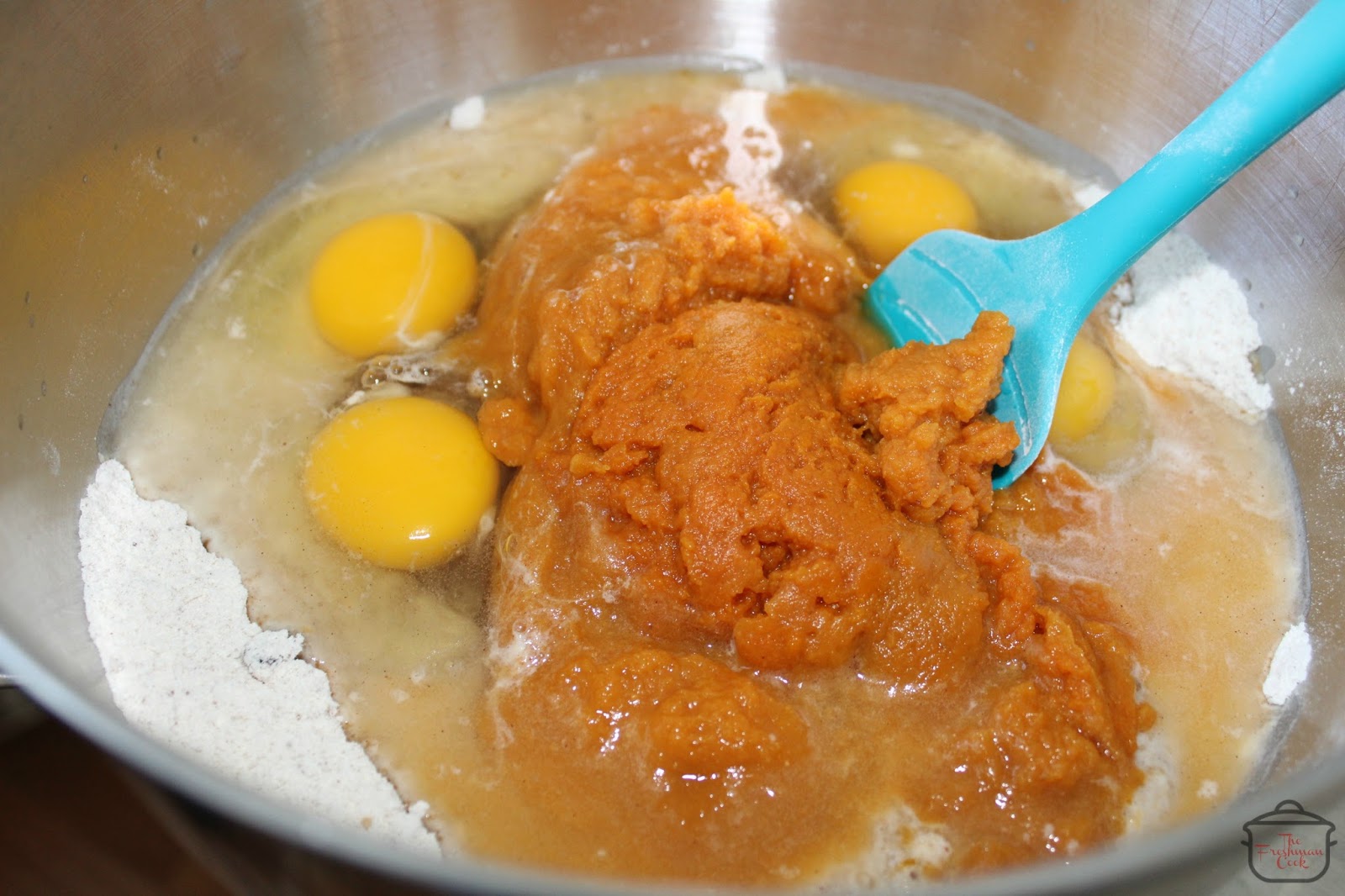 Add corn syrup, eggs, water, and pumpkin. Mix just until the batter is evenly combined, then fold in the chopped pecans