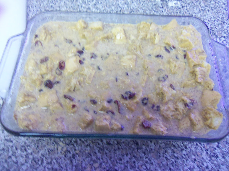 Pour the pumpkin custard over it and add the cranberries. Press the bread down gently so it becomes thoroughly soaked