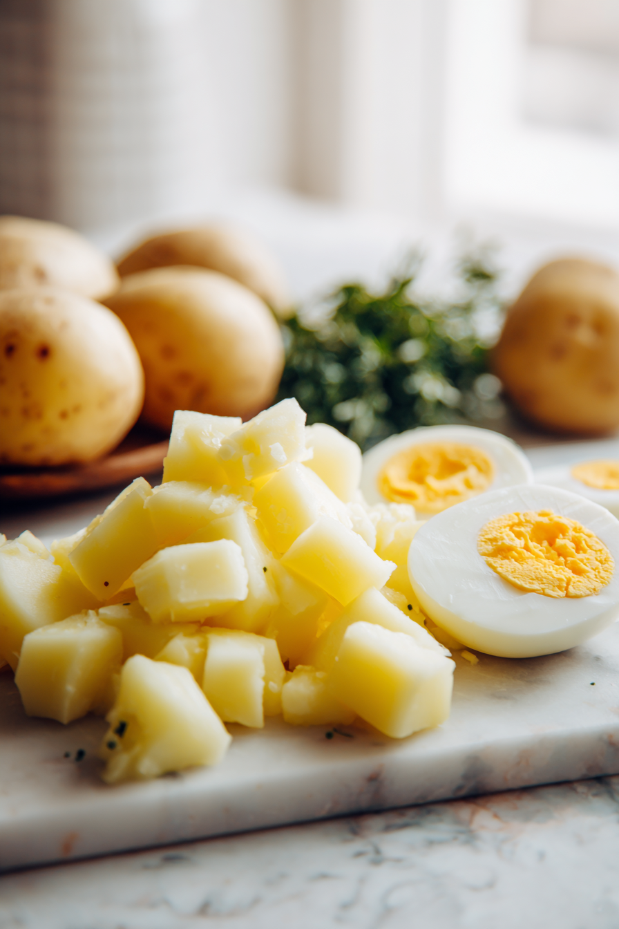Firstly, boil the potatoes and eggs until they're soft
