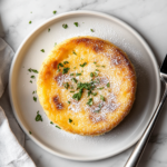 This image shows a beautifully baked cassava cake, topped with a golden caramelized custard layer, served on a plate, capturing the rich and indulgent textures of this classic Filipino dessert.