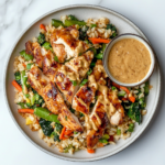 his image shows a beautifully presented plate of hibachi chicken, served with sautéed vegetables, fried rice, and a side of mustard sauce, making a perfect homemade Japanese meal.