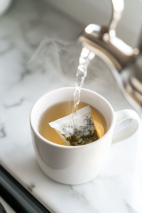 This image shows green tea and chamomile tea bags steeping in hot water, releasing their flavors into the water to create the base of the cortisol cocktail.