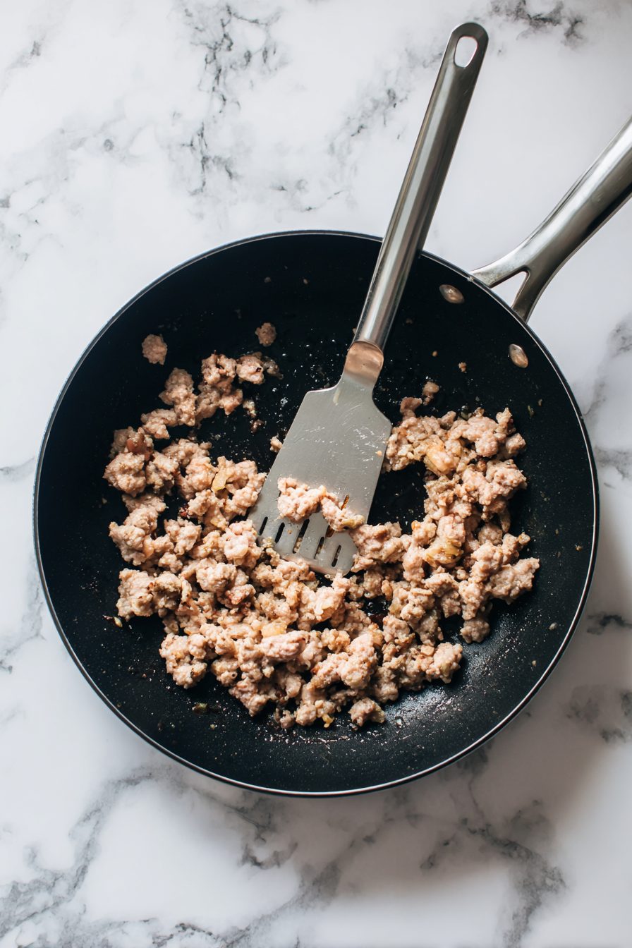 In a large skillet over medium-high heat, cook and crumble the sausage until evenly browned, approximately 10 minutes.