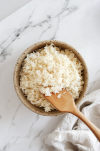 This image shows the perfectly cooked Calrose rice being fluffed with a fork, ready to be served as a side dish or meal base.