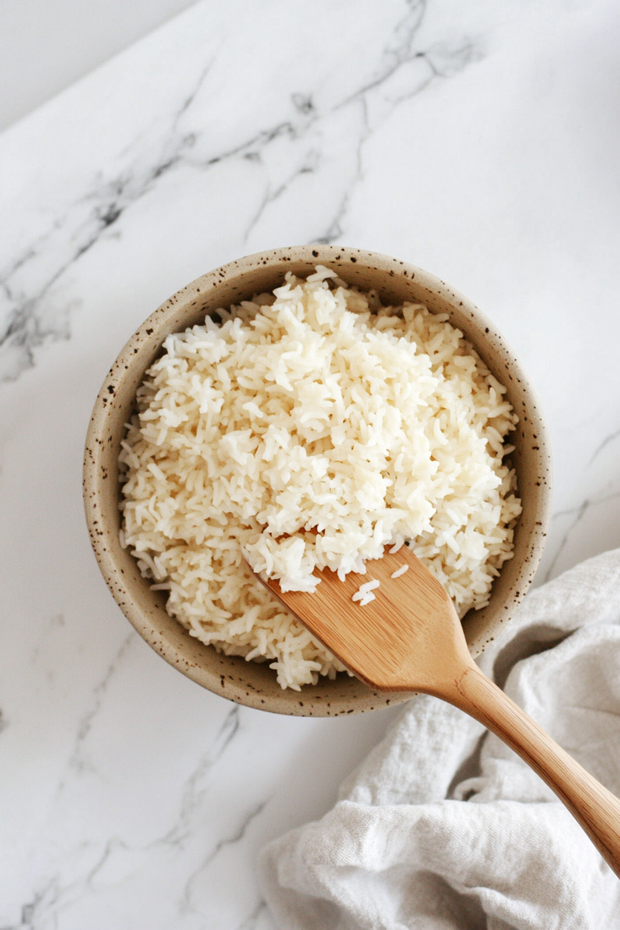 This image shows the perfectly cooked Calrose rice being fluffed with a fork, ready to be served as a side dish or meal base.