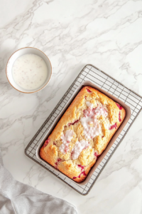 This image shows the Gouda grits reaching a perfect creamy consistency, with melted cheese and butter mixed in, ready to be served as a comforting dish.