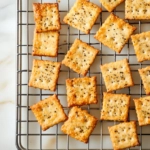 The finished crackers cool on a wire rack on the marble cooktop, ready to enjoy on their own or paired with a favorite dip.