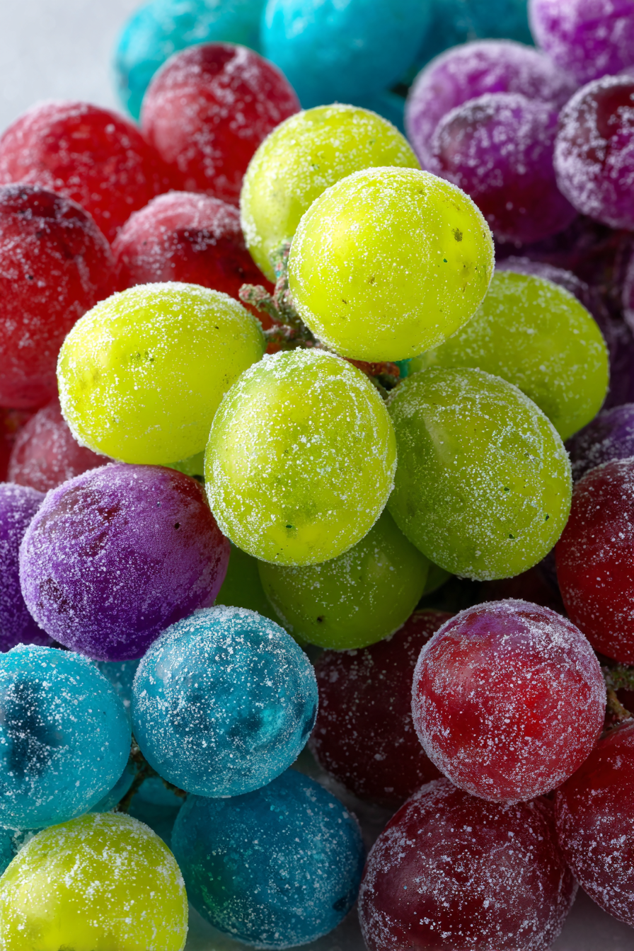 Add the Kool-Aid mixture to each bag, seal tightly, and shake until the grapes are heavily coated in vibrant candy-like powder.