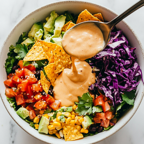 This image shows a small bowl filled with a vibrant blend of homemade Taki seasoning, showcasing its rich colors and textures, perfect for sprinkling on snacks and dishes.