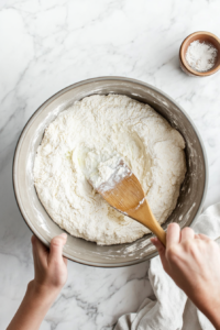 This image shows the dry ingredients and chopped pickles being folded into the wet mixture, creating a balanced and flavorful batter for the pickle cupcakes.