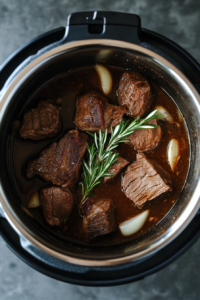 This image shows sliced onions being sautéed to a golden brown in the Instant Pot, with minced garlic added for a fragrant and flavorful base for the beef.