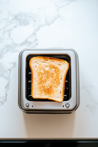 This image shows a slice of bread being toasted until golden brown and crisp, creating the perfect base for creamy avocado in the avocado toast recipe.