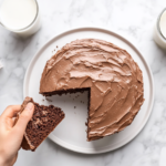 This image shows a fully frosted chocolate Nutella cake with a smooth Nutella topping, ready to be served as a decadent dessert, perfect for any occasion.