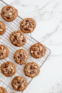 This image shows freshly baked Nutella cookies cooling on a wire rack, ready to be enjoyed warm or at room temperature with their gooey centers and crispy edges.