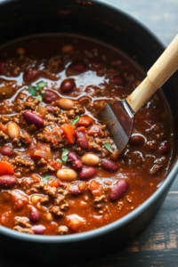 This image shows chili seasoning, kidney beans, and pinto beans being mixed into the pot, creating the rich and hearty flavor of Wendy’s chili.