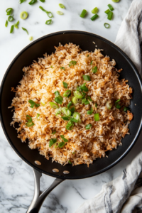 This image shows golden crispy rice served on a platter, garnished with fresh scallions, ready to be enjoyed as a flavorful main dish or side.