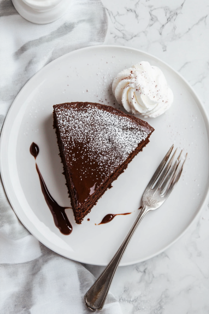 This image shows the Nutella cake being sliced and served on a plate, showcasing its rich, moist texture and chocolatey goodness, ready to be enjoyed.