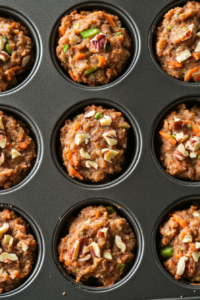 This image shows the muffin batter being spooned into the prepared muffin tin, with each cup being filled about two-thirds full, ready for baking.