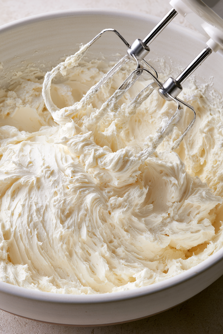 In a large bowl, beat together the butter, cream cheese, and powdered sugar until fluffy
