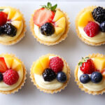 this image shows cheesecake cusps topped with chopped fruits