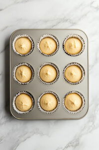 this image shows vegan Morning Glory Muffins batter in muffin tin for baking