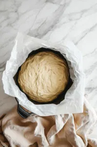 this is an image of bread dough in a Dutch oven ready for baking