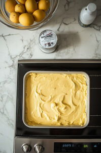 This image shows the cake in a pan placed in the refrigerator to chill for at least an hour before serving.