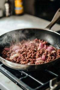 This image shows the Maid Rites mixture being spooned into warm buns, ready to be served.