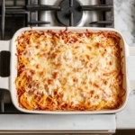 This image shows a golden-brown spaghetti squash casserole in a baking dish, topped with melted cheese, ready to be served