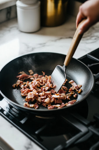 this image shows Crispy bacon being cooked in a large Dutch oven over medium heat.