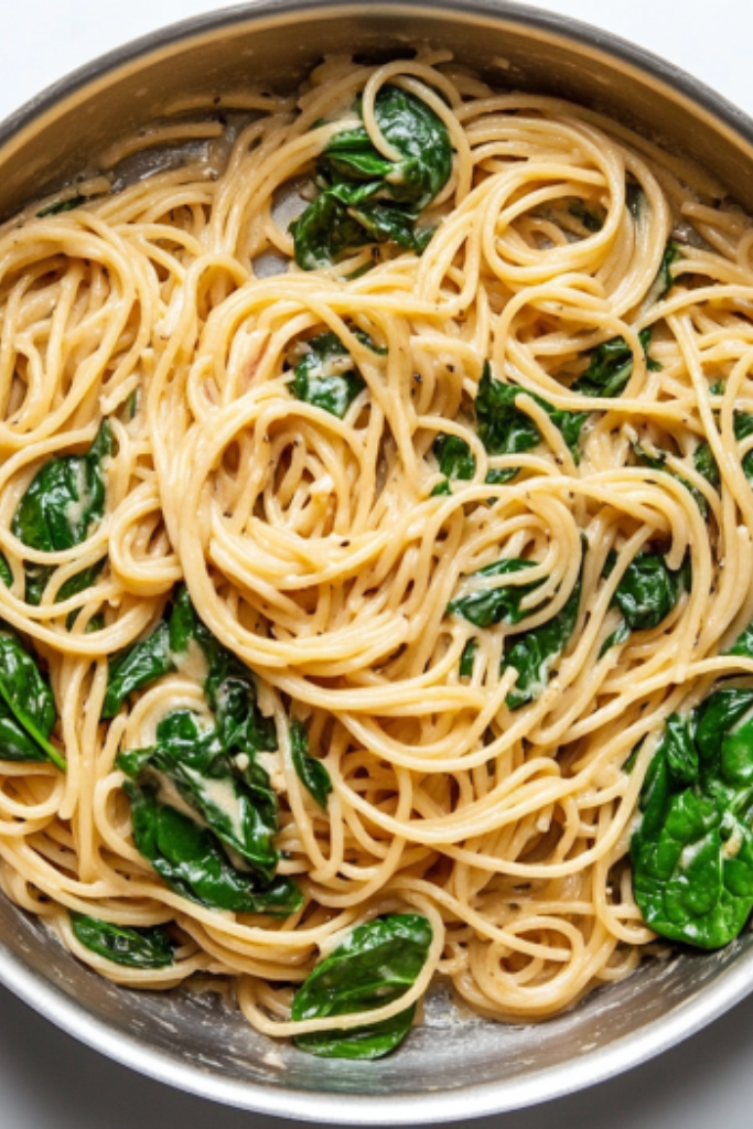 the image shows Creamy-Spinach-Sun-Dried-Tomato-Pasta ready to serve