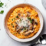 This image shows the finished risotto, seasoned with salt, pepper, and garnished with fresh parsley.