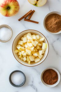 This image shows apples neatly placed in the bottom of a slow cooker, ready to be cooked.