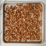 this image shows golden brown Mashuga nuts in a baking tray