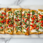 This image shows the finished cream cheese veggie bread being sliced and served on a platter, ready to be enjoyed immediately or refrigerated.