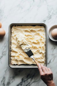 This image shows a freshly baked cake in a 9x13" pan, cooling completely after being removed from the oven.