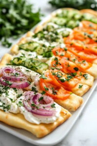 This image shows chopped vegetables being pressed into the cream cheese mixture, with parmesan and garnishes sprinkled on top.