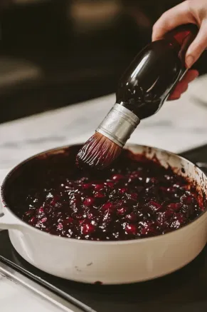 Once cooled, the cake sits on the cooktop as it’s brushed with additional rum or brandy, which adds extra richness and a deep, festive appearance.