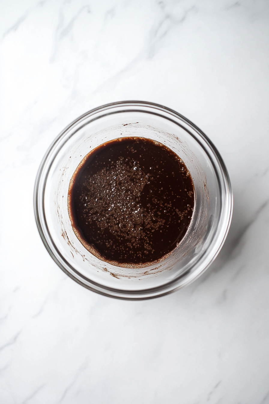 In a microwave-safe bowl, combine the dark chocolate chips and 1 tablespoon of coconut oil. Microwave in 20-second increments, stirring in between, until fully melted.