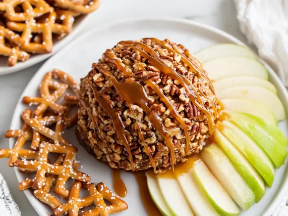 Roll the ball in the remaining pecans for a crunchy coating. Place on a serving platter, drizzle with extra caramel, and serve with apple slices, graham crackers, or pretzel chips for dipping.