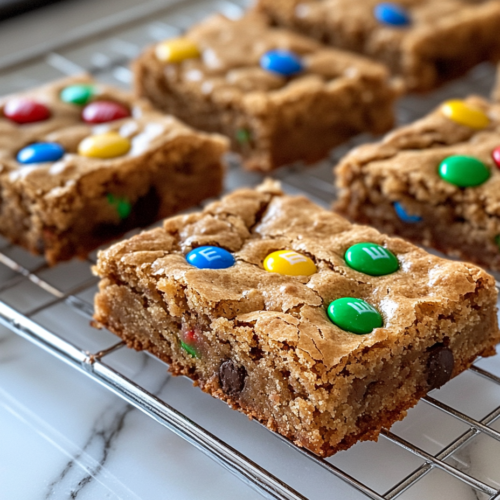 A baking pan with blondie batter sits inside the preheated oven. The edges begin to turn golden brown, and the aroma of baking fills the air.