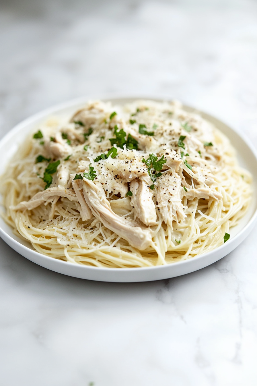 Delicious Crock Pot Angel Chicken for Family Dinners: Serve the creamy chicken over the pasta and garnish with parsley, pepper, or Parmesan if desired.