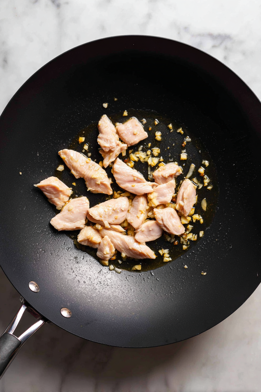 Add sliced chicken and cook until no longer pink.